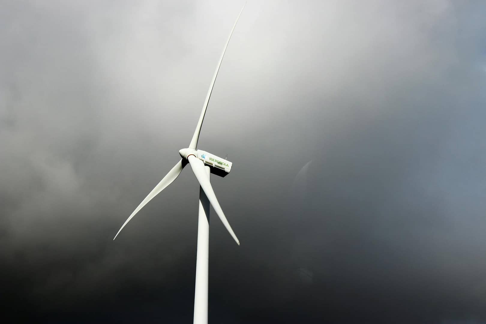 white windmill under gray cloudy sky