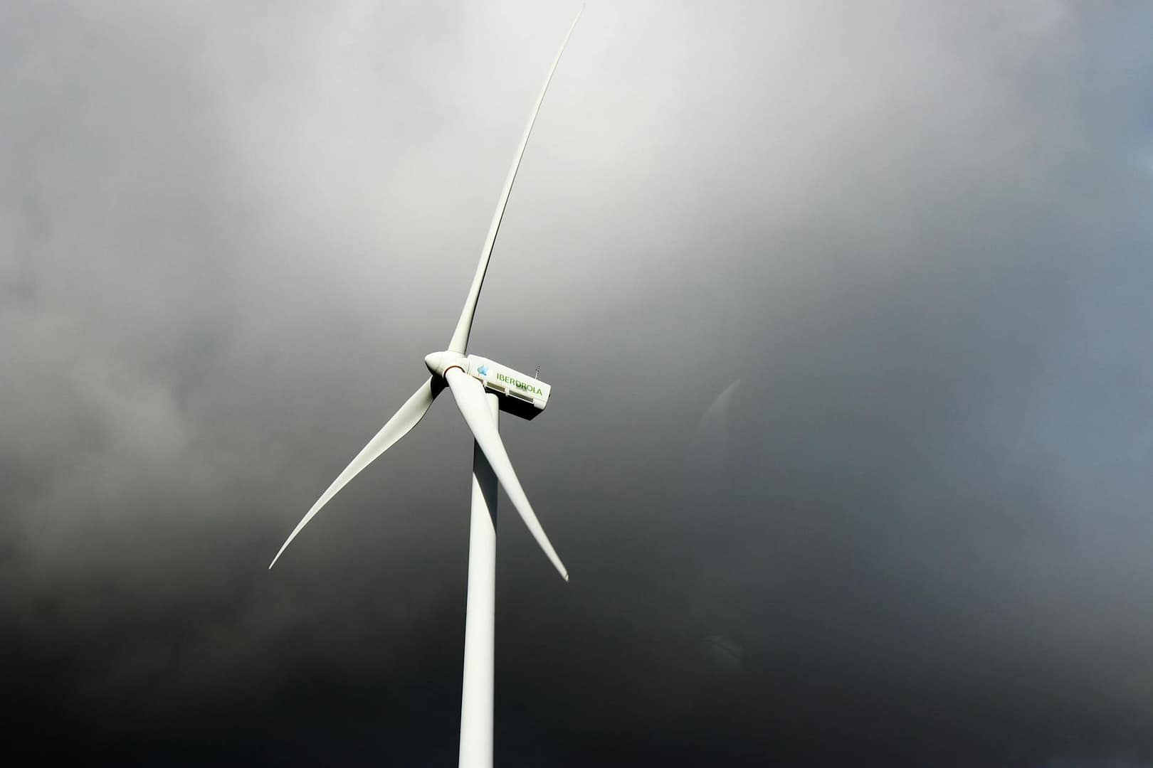 white windmill under gray cloudy sky