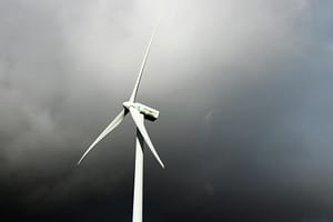 white windmill under gray cloudy sky