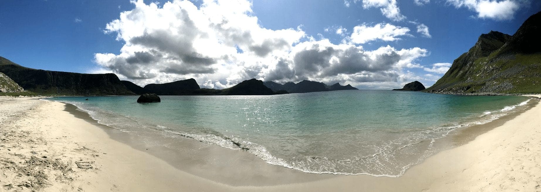 Lofoten, Norway is great. Bring your kids, surf, hike and try dried fish.