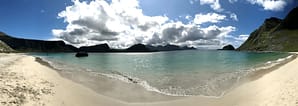 Lofoten, Norway is great. Bring your kids, surf, hike and try dried fish.